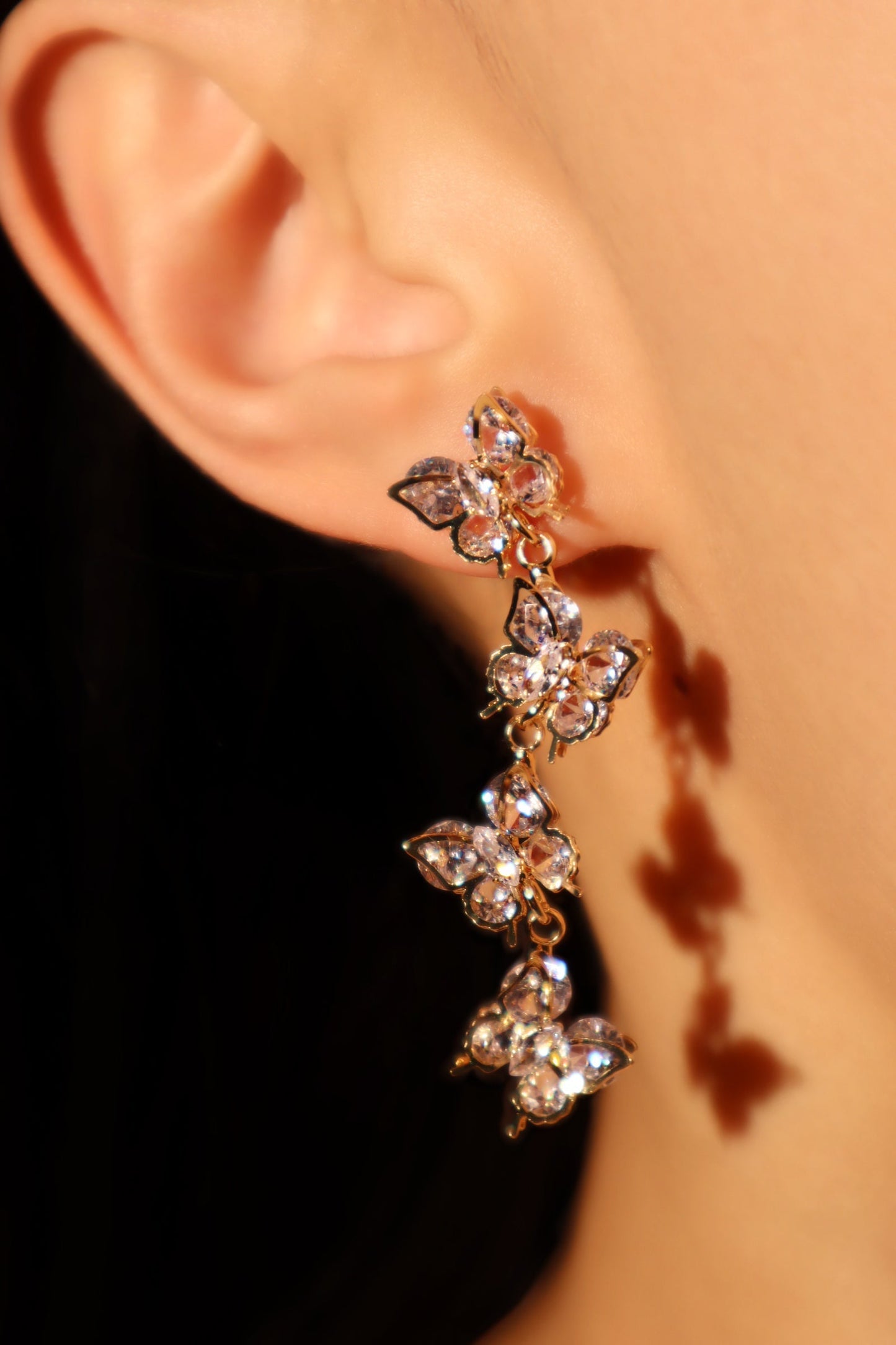 Aretes colgantes con forma de mariposa y diamantes